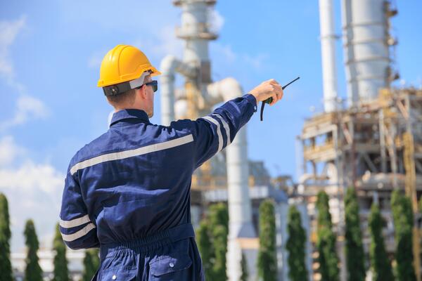 petroleum-industry-engineer-worker-working-outdoor-refinery-plant-oil-and-gas-service-team-control-operate-maintenance-front-of-large-complex-gas-pipe-building-with-radio-photo
